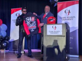 Clark Atlanta University President George T. French, Jr., presents Usher with a hat during a homecoming rally for Usher at Clark Atlanta University in Atlanta on Wednesday, February 14, 2024. Along with other honors, Amazon presented a $25,000 donation to Usher’s New Look Foundation. (Arvin Temkar / arvin.temkar@ajc.com)
