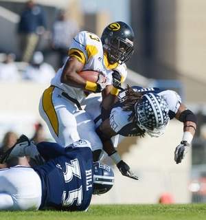 Dawrence Roberts runs through two JSU's defenders