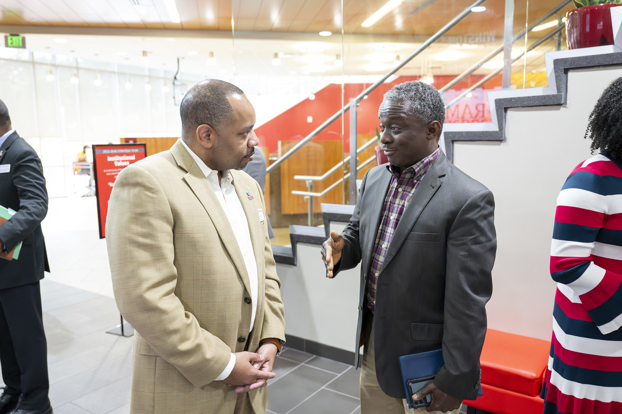 Two attendees engaged in a conversation.  