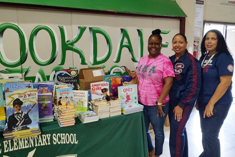 Brookdale Elementary School Principal Georgetta Kennedy, the SC State Miller F. Whittaker Library’s Cathi Cooper Mack, and the Honors College’s Dr. Windy Stephenson, with books donated for students.