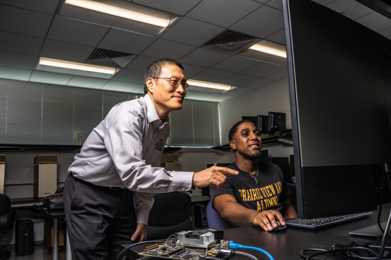 Lijun Qian, Ph.D. with student