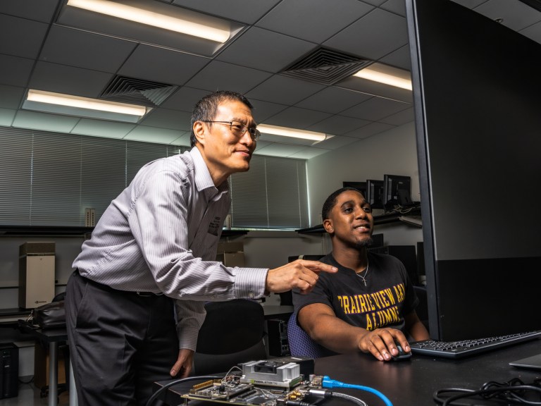 Lijun Qian, Ph.D. with student