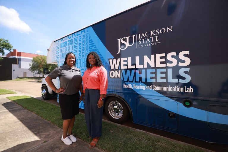 Dr. Brandi Newkirk-Turner and Dr. Whitney Perkins standing in front of the mobile lab.