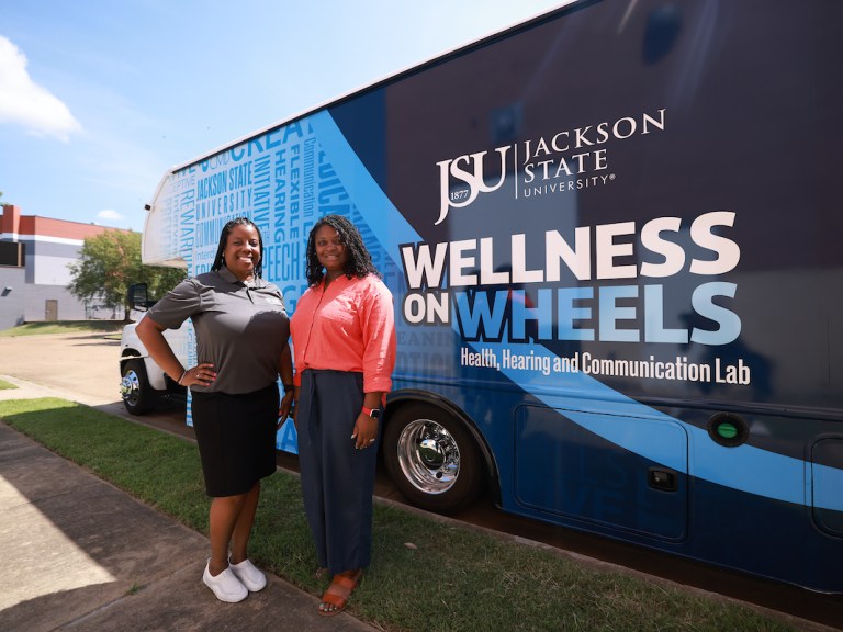 Dr. Brandi Newkirk-Turner and Dr. Whitney Perkins standing in front of the mobile lab.