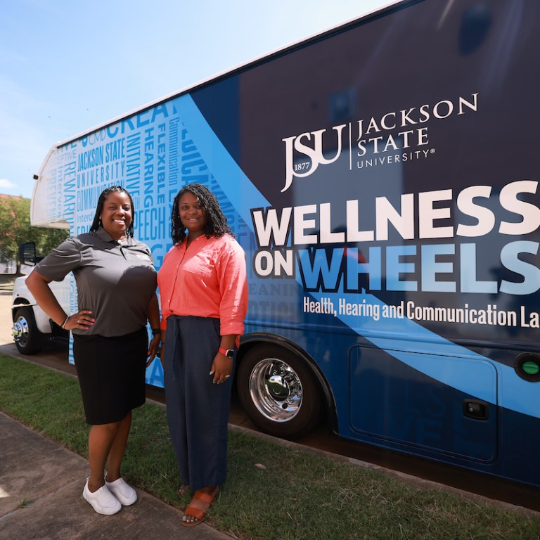 Dr. Brandi Newkirk-Turner and Dr. Whitney Perkins standing in front of the mobile lab.