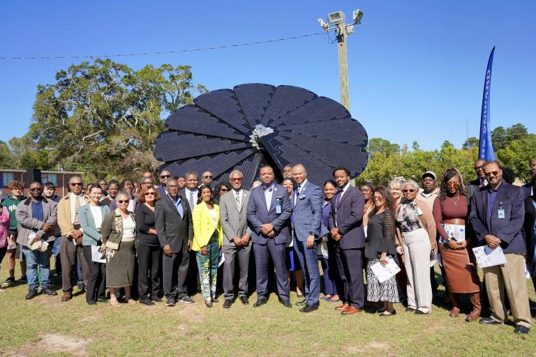 Attendees gather to celebrate the unveiling of the SmartFlower.