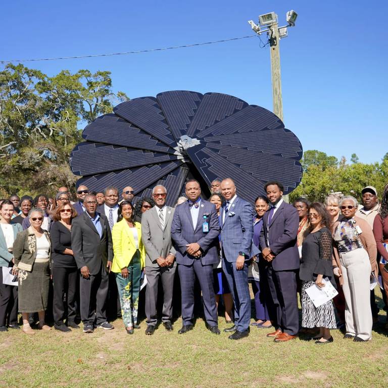 Attendees gather to celebrate the unveiling of the SmartFlower.