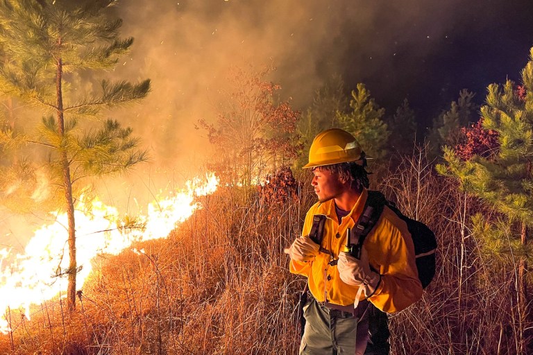 Firefighter student overlooks a fire.