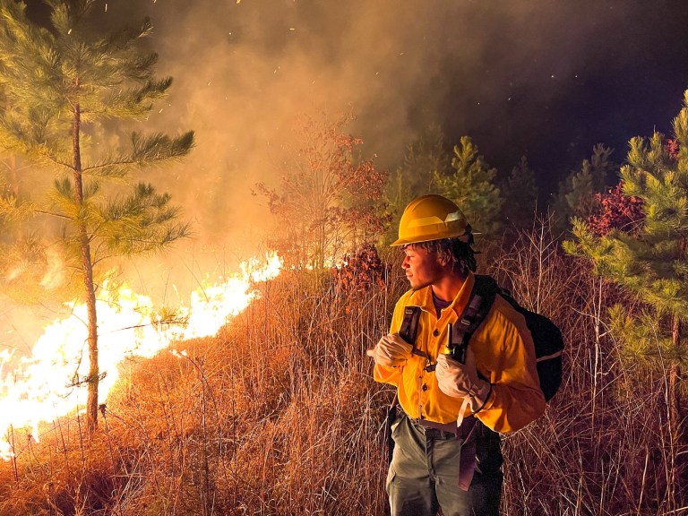 Firefighter student overlooks a fire.