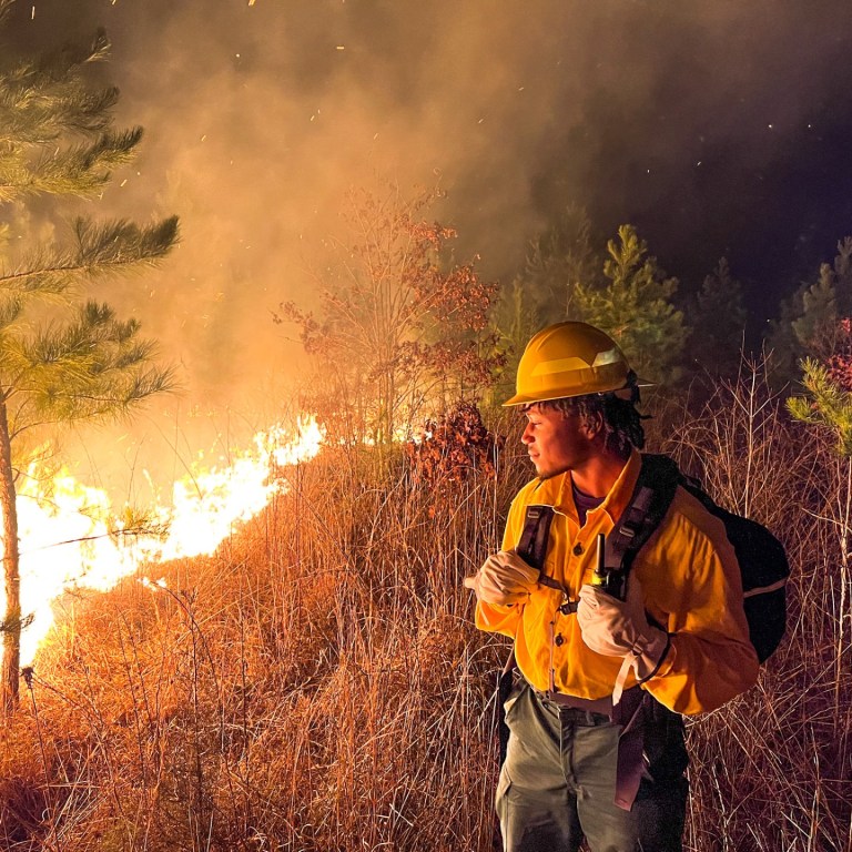 Firefighter student overlooks a fire.