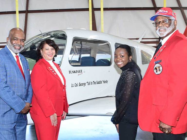 (L-r) Retired Brig. Gen. Robert D. Bowie, Dr. Joi Spraggins, Board Chairman and Founder/CEO of Legacy Bridges STEM Academy Inc., respectively; Soledad Quaninoo and Legacy Bridges Board member Andrew Holloway; all pose at DSU’s Piper Arrow aircraft that now bears the name of Lt. Col. George “Tall in the Saddle” Hardy, who was a WWII pilot for the legendary Tuskegee Airmen.