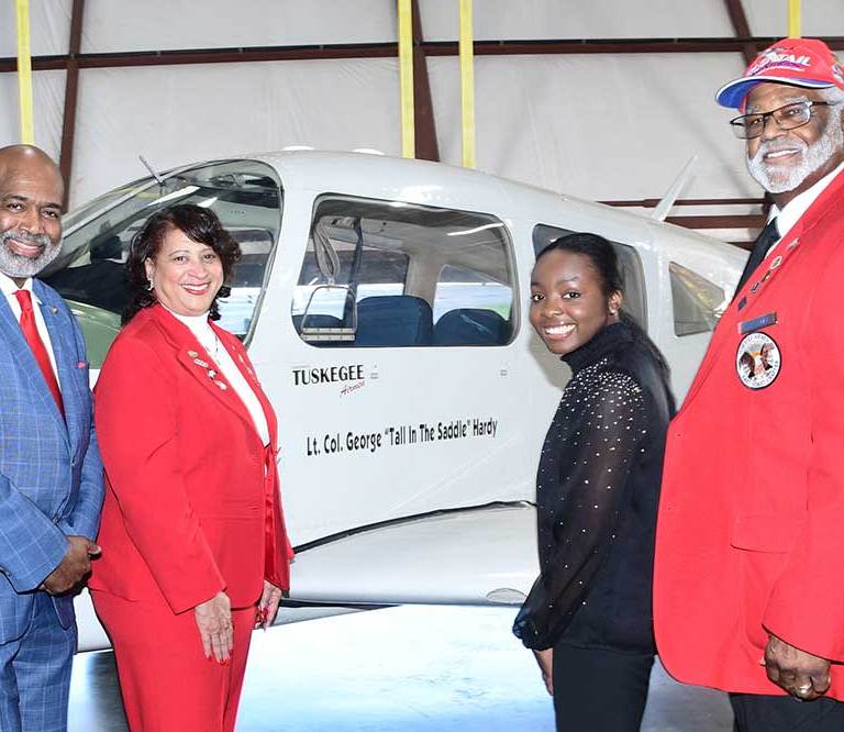 (L-r) Retired Brig. Gen. Robert D. Bowie, Dr. Joi Spraggins, Board Chairman and Founder/CEO of Legacy Bridges STEM Academy Inc., respectively; Soledad Quaninoo and Legacy Bridges Board member Andrew Holloway; all pose at DSU’s Piper Arrow aircraft that now bears the name of Lt. Col. George “Tall in the Saddle” Hardy, who was a WWII pilot for the legendary Tuskegee Airmen.