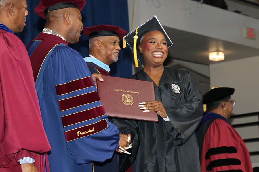 Inara Brady accepts her psychology degree from SC State President Alexander Conyers.