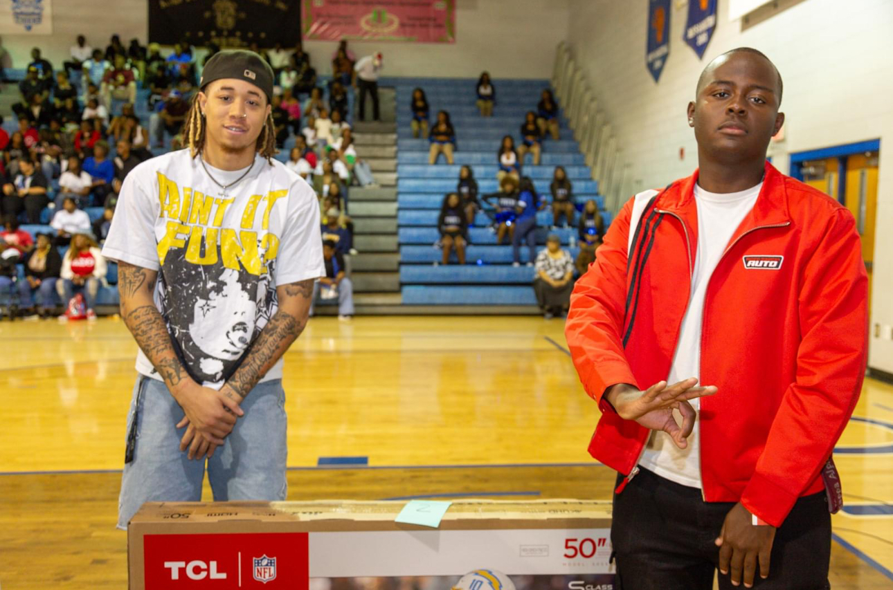 Kappa Alpha Psi members present television donation.